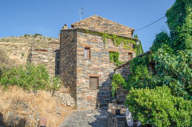 Typical architecture in the town of Patones de Arriba, Spain, one of the most representative examples of so-called black architecture (uses slate as the main construction element, a mineral compound of gray, violet, bluish, brown, silver or blackish  clipart