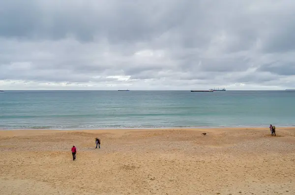 stock image SANTANDER, SPAIN - MAY 1, 2014: People walking on Sardinero beach in Santander, Cantabria, northern Spain