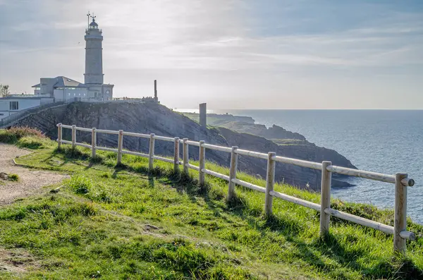 stock image Rocky coast with the Cabo Mayor lighthouse in the background, Santander, Cantabria, northern Spain