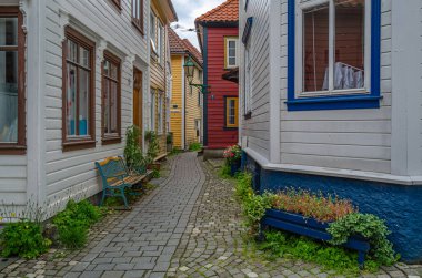 BERGEN, NORWAY - JULY 17, 2014: Narrow streets with colorful wooden houses in the city of Bergen, Norway clipart