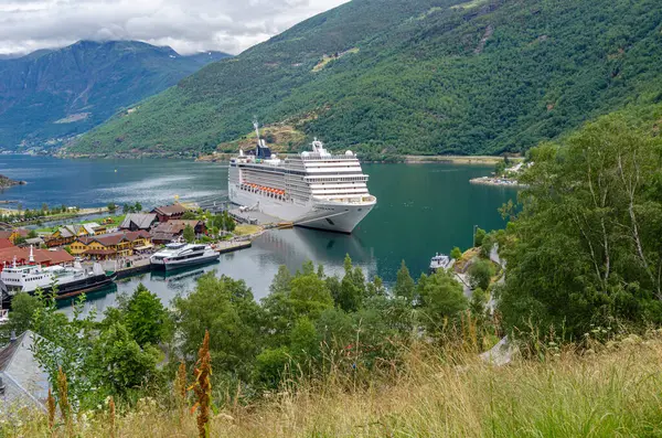 stock image FLAM, NORWAY - JULY 16, 2014: View of cruise ships docked in the tourist village of Flam, on the shore of Aurlandsfjord, Vestland county, Norway