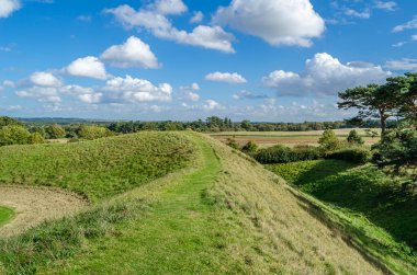 CASTLE RISING, UNITED KINGDOM - OCTOBER 10, 2014: View of the surroundings and earthworks of Castle Rising Castle, a ruined medieval fortification in the village of Castle Rising, Norfolk, England, built in 1138 clipart