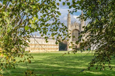 CAMBRIDGE, UNITED KINGDOM - OCTOBER 11, 2014: King's College in Cambridge, UK, seen from The Backs. King's College is a constituent college of the University of Cambridge clipart