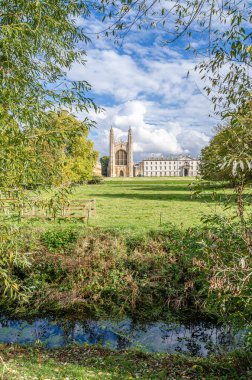 CAMBRIDGE, UNITED KINGDOM - OCTOBER 11, 2014: King's College in Cambridge, UK, seen from The Backs. King's College is a constituent college of the University of Cambridge clipart