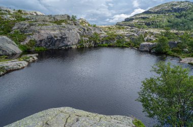 Norveç 'in Rogaland ilçesinde turistik bir yer olan Preikestolen (Kürsü Kayası) rotasındaki dağ gölü, Lysefjorden' ın 604 metre yukarısına kadar uzanan dik bir uçurum.