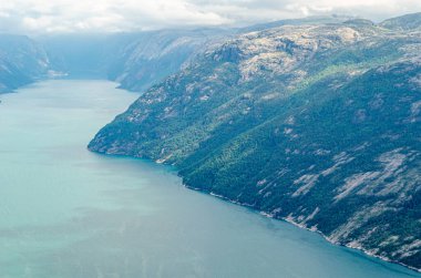 View of Lysefjorden fjord from Preikestolen (The Pulpit Rock), a tourist attraction in Rogaland county, Norway, a steep cliff which rises 604 meters above the fjord clipart