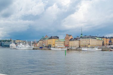 STOCKHOLM, SWEDEN - 27 Temmuz 2014: Stockholm, İsveç 'teki şehir manzarası, arka planda fırtına bulutları olan rıhtım binalarının manzarası