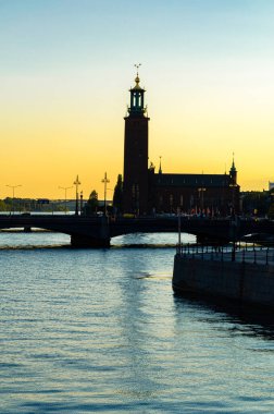 Stockholm, İsveç 'te alacakaranlıkta rıhtımdaki binaların silueti.