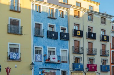 CUENCA, SPAIN - MARCH 28, 2015: Buildings in the old town of Cuenca, Castilla la Mancha, Spain, with their facades decorated during Holy Week
