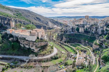 CUENCA, SPAIN - MARCH 29, 2015: Panoramic view of the Huecar Gorge with the town of Cuenca, Spain. In the foreground, the former Convent of San Pablo, since 1993 it houses a state-owned Parador hotel