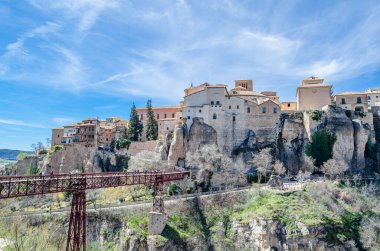 CUENCA, SPAIN - MARCH 28, 2015: People crossing the San Pablo Bridge, an iron and wood beam bridge spanning the Huecar River in Cuenca, Spain, opened in 1903