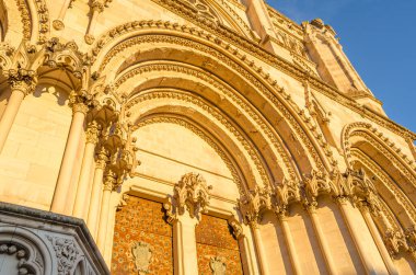 Dusk view of the Gothic Cathedral of Saint Mary and Saint Julian, with facade illuminated by warm light. It is a Catholic cathedral in the town of Cuenca, Castilla La Mancha, Spain