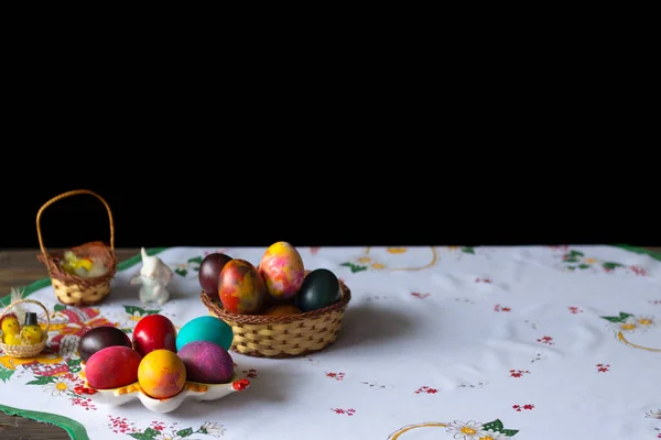 Colored Easter Eggs Wooden Basket White Tablecloth Black Background — Stock Photo, Image