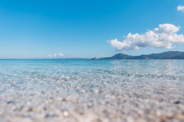 Gökyüzü ve adayla berrak mavi ufuk ve berrak masmavi suyla güzel bir deniz