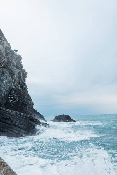 Beautiful rock with a raging sea in Vernazza, Italy