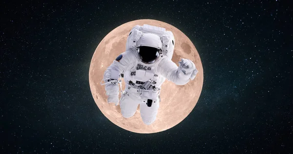 Space man astronaut flies in outer deep starry space on the background of the full moon. Space mission and trip to the moon, concept