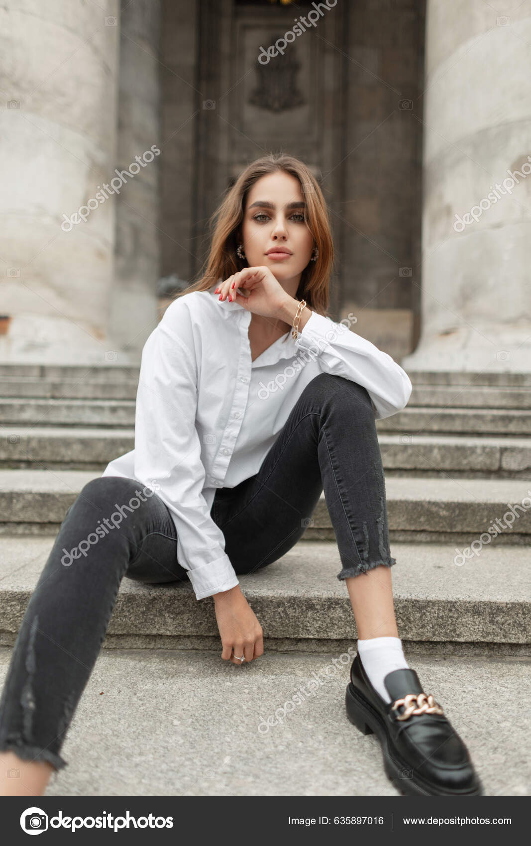 posing. girl model posing in black jeans with a high waist and a belt, a  white T-shirt. posing lessons. photo session in the studio. female poses  Stock Photo | Adobe Stock