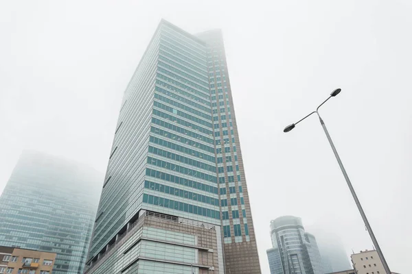 Office and business buildings in the foggy city of Warsaw, Poland