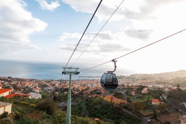 Beautiful panoramic view of the city of Funchal with houses, ocean, mountain and cable cars on the island of Madeira