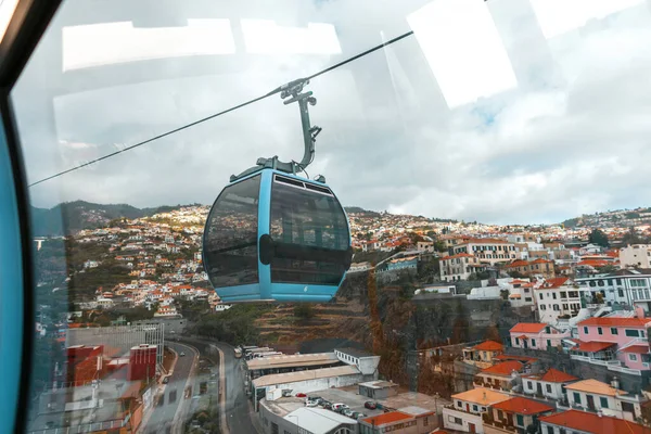 Cabin cable car rides over the beautiful vintage city of Funchal in Madeira island
