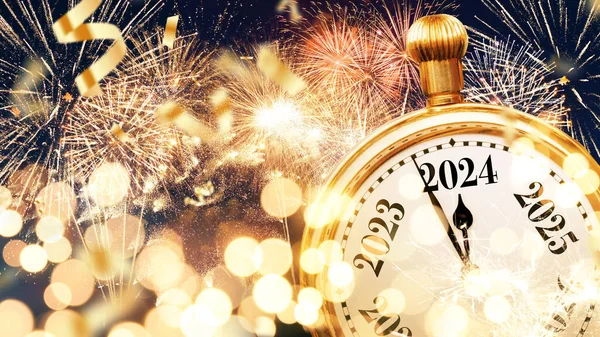 Vintage gold clock hands pointing to New Year 2024 with bokeh yellow lights, confetti and fireworks, creative idea. Merry Christmas and New Year card. Holiday countdown. Start of the New Year