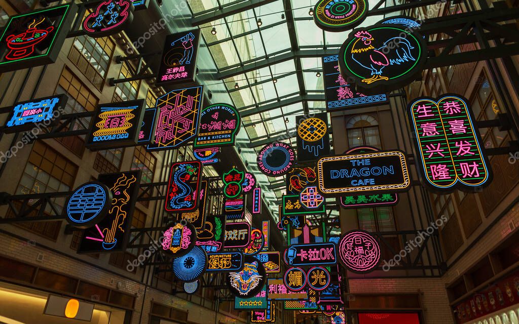Neon signs advertising in Chinatown. Creative decor with light Chinese signs shapes and hieroglyphs in Dubai Mall