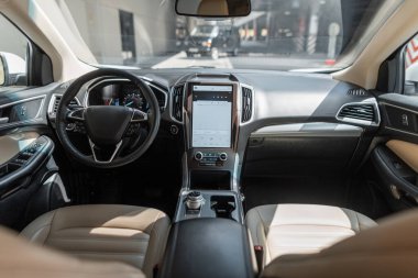 Direksiyon, vites ve ön koltukları olan modern bir araba.