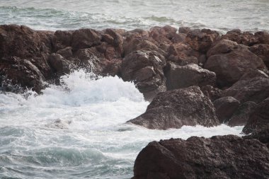 Dalgalar kayalara çarpıyor.