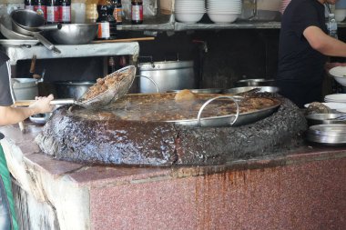 Bangkok, Thailand - November 26, 2024: big pan full of stewed beef and goat meat is seen in Wattana Panich restaurant, one of the most famous Chinese style beef noodle restaurants in bangkok clipart