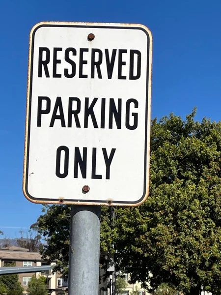 RESERVED PARKING ONLY sign at a business parking lot