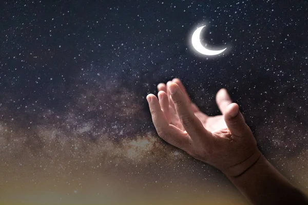 Muslim hand man pray in dark with moon sky background, Male worship to god with faith and belief in black, Arab muslim male person praying for Allah\'s blessing with hope. concept religion islam.
