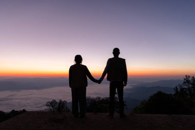 silhouette of wedding Couple in love holding hand together during sunrise with morning sky background. Pre-wedding portraits. happy couple images man and woman with sky nature background