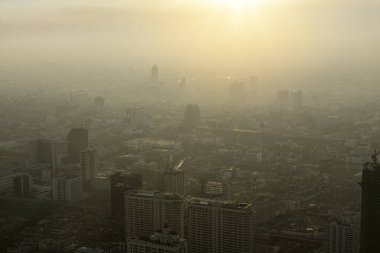 Bad air pollution in City. PM 2.5 dust in Bangkok or center city, Capital city are covered by heavy smog, Misty morning and sunrise in downtown with bad air pollution, Place to risk of cancer,Thailand