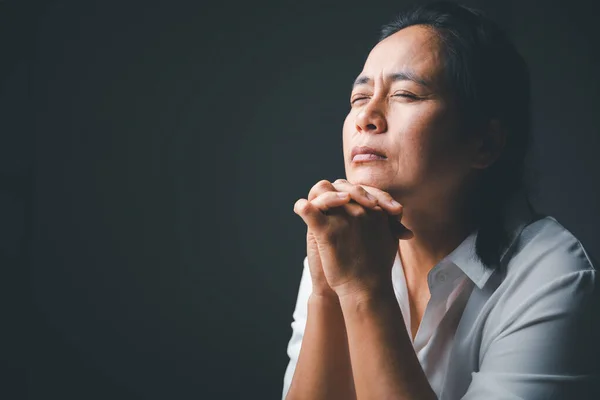 Christian catholic life crisis prayer to god. Woman pray to god for blessing to wishing have a better life. Person hands praying to god. Begging for forgiveness and believe in goodness.Female worship