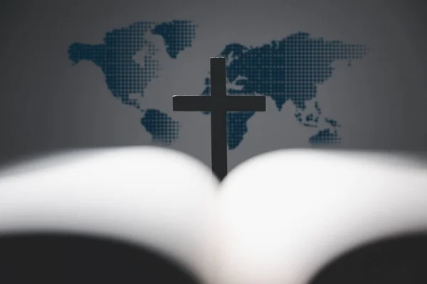 Cross with open Holy Bible on table with world map blur background. mission evangelism and gospel on world. Copy space for text, Christian background for great commission or earth day concept.