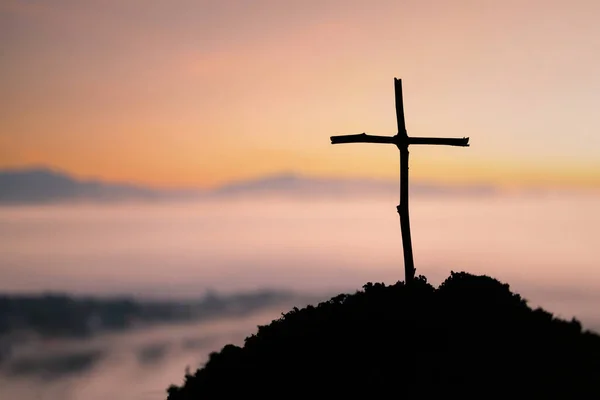 Crucifixion Of Jesus Christ - Cross At Sunset. The concept of the resurrection of Jesus in Christianity. Crucifixion on Calvary or Golgotha hills in holy bible.