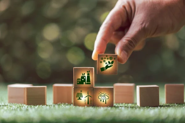 Companies are targeting net zero greenhouse gas emissions. Carbon credit concept.Tradable certificate to drive industry in direction of low emissions in efficiency cost.Wooden cubes with decrease CO2