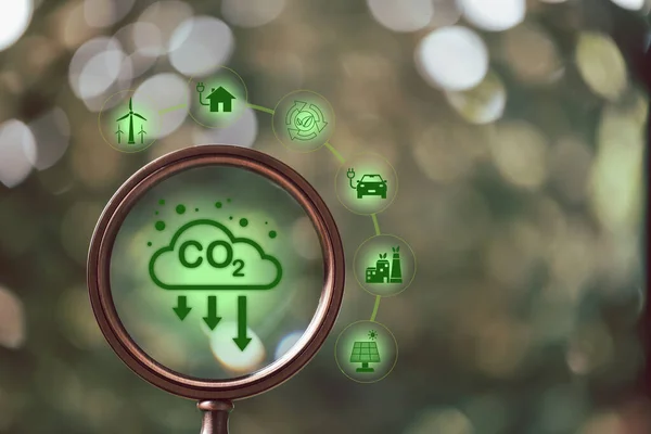 Magnifying glass with carbon reduction icon. Concept of reducing carbon emissions in production and service. Reduce carbon emissions in industry protect atmosphere and ecology and environment.
