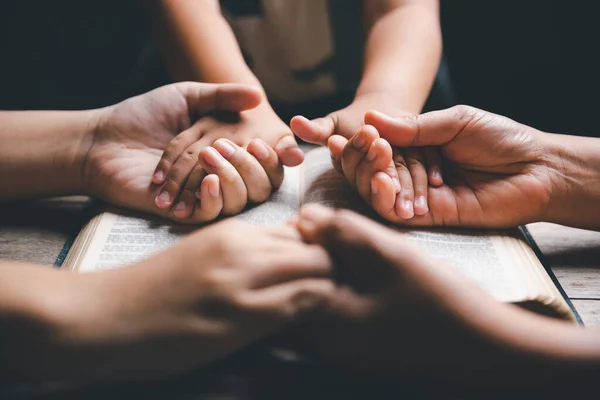stock image Christian family praying together concept. Child and mother worship God in home. Woman and boy hands praying to god with the bible begging for forgiveness and believe in goodness.