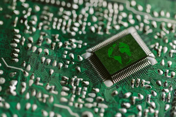 Environment green technology computer chip. Green world icon on circuit board technology innovations. Concept of green technology. Green Computing, Green Technology, Green IT, CSR, and IT ethics.