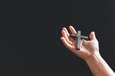 Hristiyan kadın ellerini kutsal bir haç tutarak ve ibadet ederek kapat. Spiritüellik ve din kavramı, Hristiyan haçı tutan kişi içeride dua etmeye başlıyor. Hıristiyanlar için inanç ve inanç.