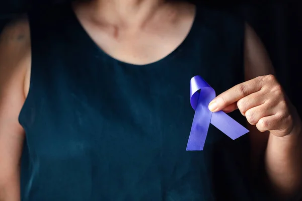 stock image Hands holding purple ribbon symbol of Alzheimer disease, world Lupus. Day and world cancer day. Pancreatic cancer, fibromyalgia awareness, Epilepsy awareness, domestic violence awareness.