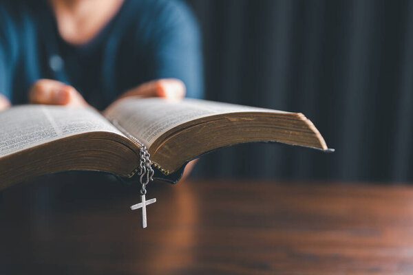 Christianity woman catholic with cross crucifix pray to god, person prayer in church concept of religion, spirituality, religious, believe, faith, hope, worship.