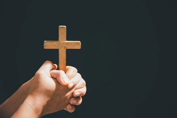 Christian life crisis prayer to god. Woman pray for god blessing to wishing have a better life. Female hands praying to god with crucifix cross. begging for forgiveness and believe in goodness.