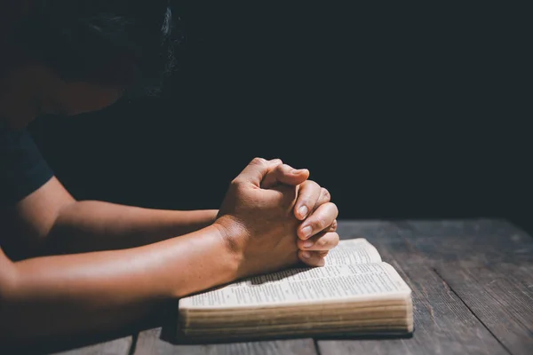 Christian life crisis prayer to god. Woman pray for god blessing to wishing have a better life. Female hands praying to god with the bible. begging for forgiveness and believe in goodness.