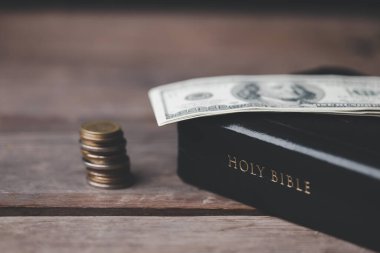 İncil 'in bize ilk meyvenin onda birini Tanrı' ya bağışlamayı öğrettiği onuncu ya da onuncu vergidir. Kutsal İncilli sikkeler. Din bağışı ve finansman. Para vermek, Hıristiyanlık bağışı sembolü.