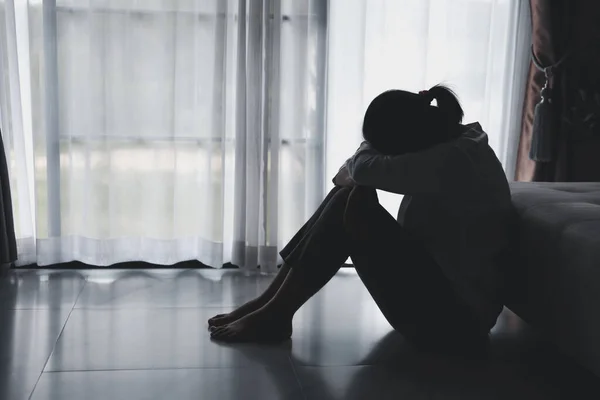 Depression person of a young woman is unhappy. Loneliness man sitting alone. Woman disappointment and hopeless. despair, headache as crying. Man is upset, frustration, tired and negative feeling.