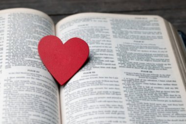 Kutsal İncil 'deki kırmızı kalp Tanrı' nın sevgisinin sembolüdür. Tanrı tüm insanlara sevgi verir. Kilisede İncil 'i görebilir ya da bulabiliriz. İncil Hristiyanlığın dinidir. Sayfada iki kalp.