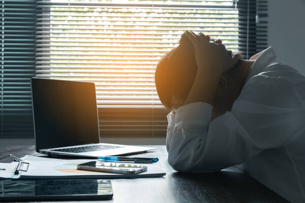 A woman battles depression and stress in her workplace, highlighting the challenges faced by professionals. This image captures the impact of mental health on employees in a corporate environment.