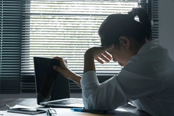 stock image A woman battles depression and stress in her workplace, highlighting the challenges faced by professionals. This image captures the impact of mental health on employees in a corporate environment.